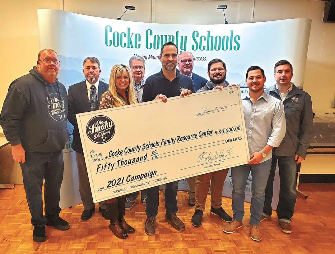 Ole Smoky Distillery donated $50,000 to the Cocke County Schools Resource Center Wednesday. Pictured, front row from left: Ole Smoky Moonshine’s Michael McCarter, Cocke County Schools Resource Center Director Diana Samples, Ole Smoky Moonshine President of Operations/Consumer Experience Cory Cottongim, Ole Smoky Senior Director of Operations Thomas Hamilton, Ole Smoky Newport Director of Operations Jamie Chen, Ole Smoky Regional Marketing Director Michael Simonis. Back row: Cocke County Director Manney Moore, Cocke County Schools Student Support Supervisor Bryan Douglas and Cocke County Assistant Director of Schools Casey Kelley.